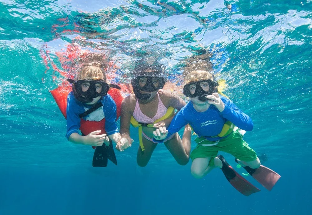 children snorkeling underwater in turks and caicos