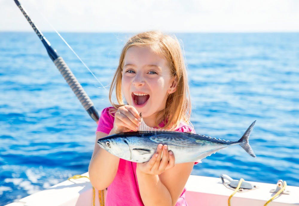 girl catches first fish on turks and caicos fishing trip