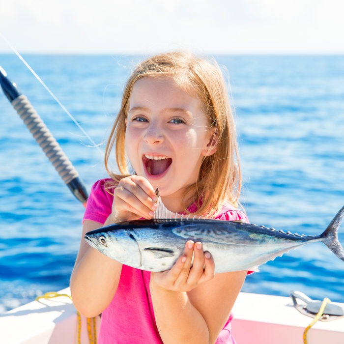 girl catches first fish on turks and caicos fishing trip