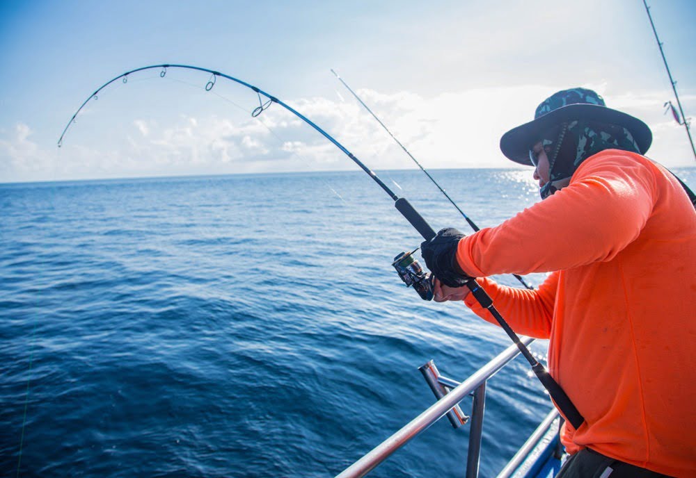 Man reeling in something huge on caicos fishing trip