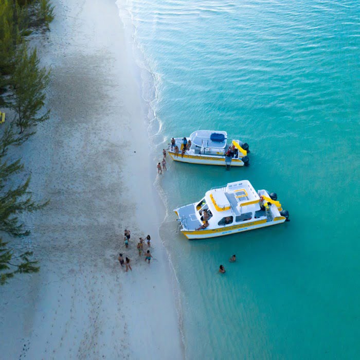 Charter boats & passengers relaxing on the beach