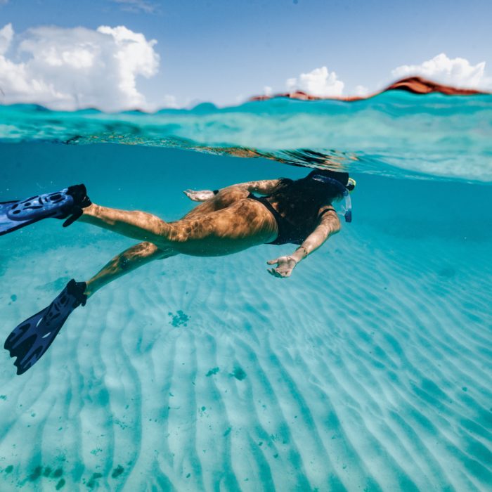woman snorkeling in the best snorkeling in turks and caicos
