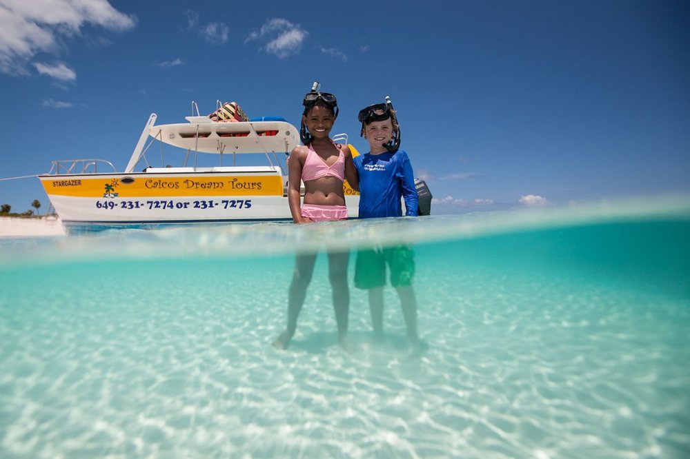 a person riding on the back of a boat in the water