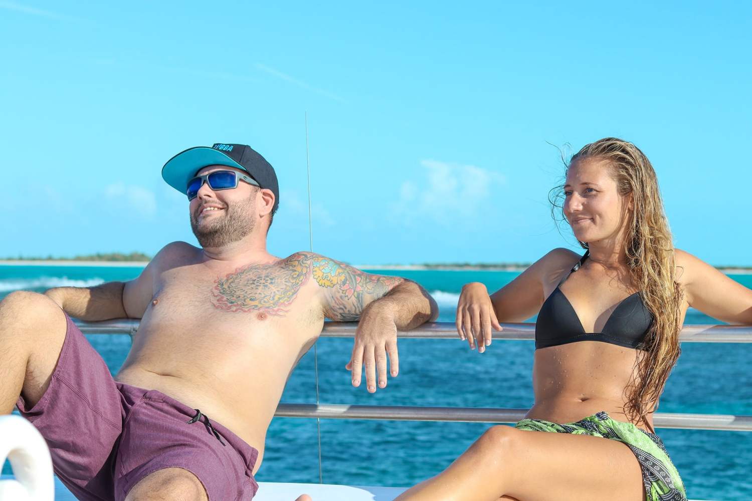 a man and a woman standing next to a body of water