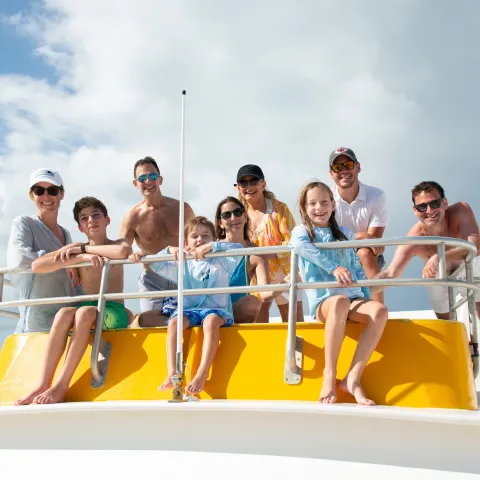a group of people sitting at a beach