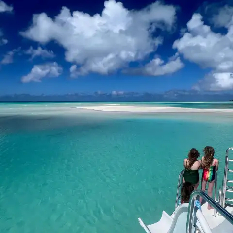 a group of people standing next to a body of water