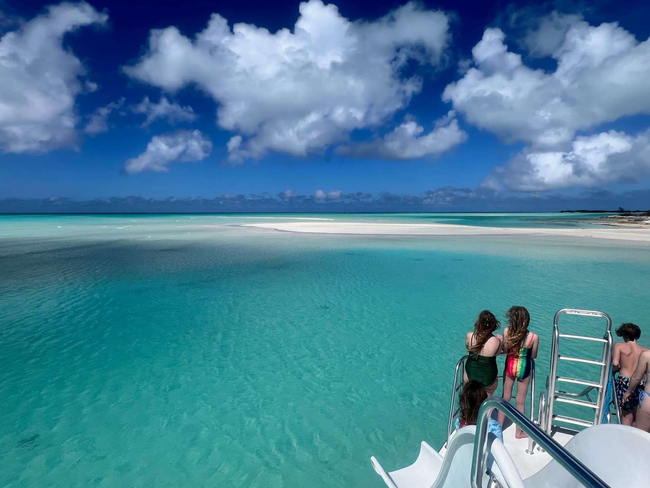a group of people standing next to a body of water