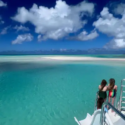 a group of people standing next to a body of water