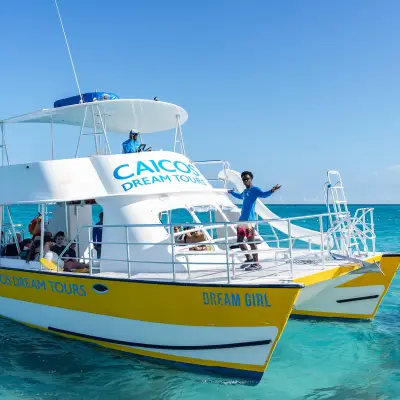 a blue and white boat sitting next to a body of water