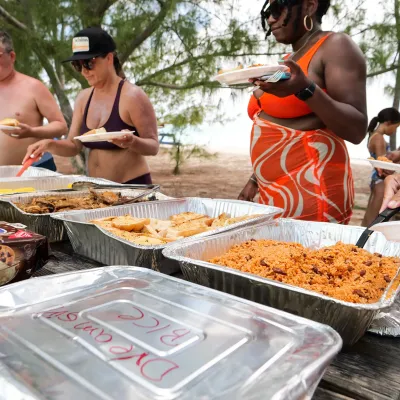 a group of people preparing food on a table
