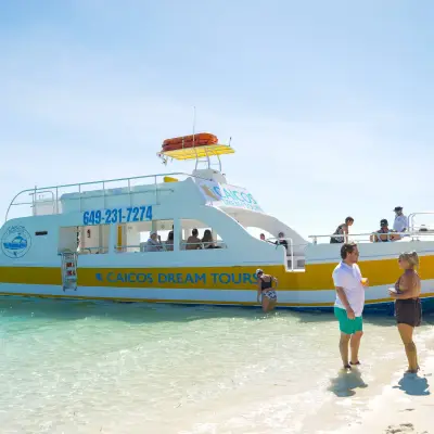 a group of people in a boat on the beach
