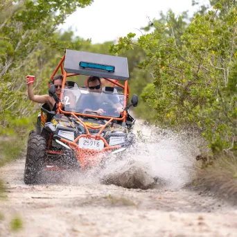 a man riding a bike down a dirt road