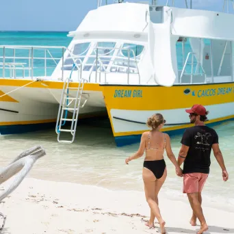 a group of people in a boat on the beach