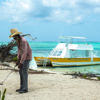 a person sitting in a boat on the beach