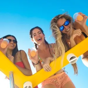 a woman holding a stuffed toy posing for the camera