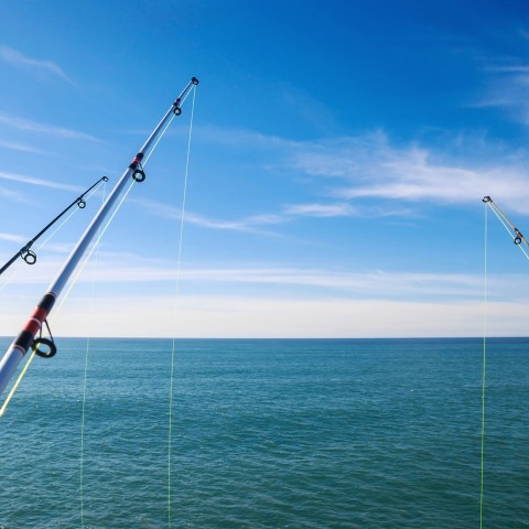 a man flying a kite in a boat on a body of water