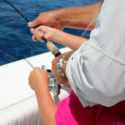 a person holding a fish in the water