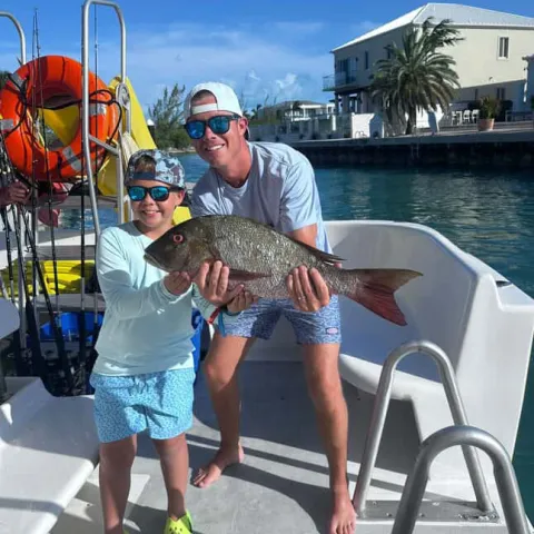 a person holding a fish in the water