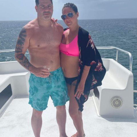 a man standing next to a body of water