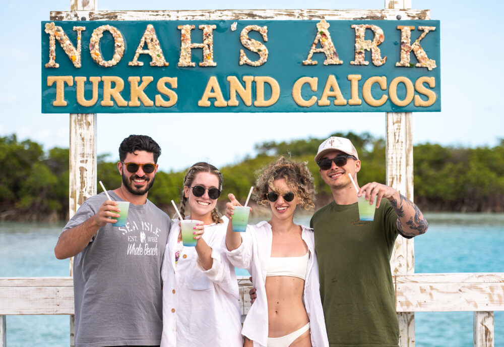 a man and a woman holding a sign posing for the camera