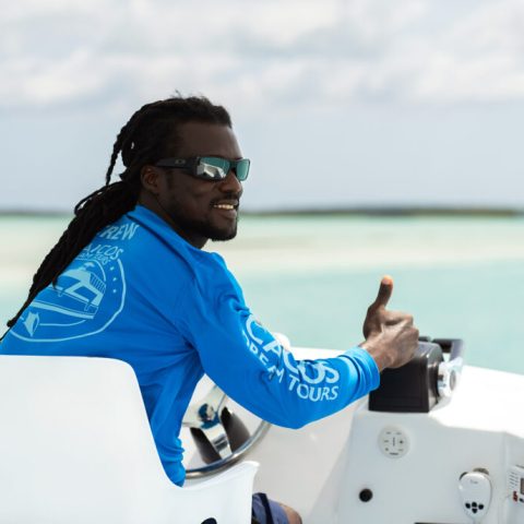 a man sitting on a boat in the water