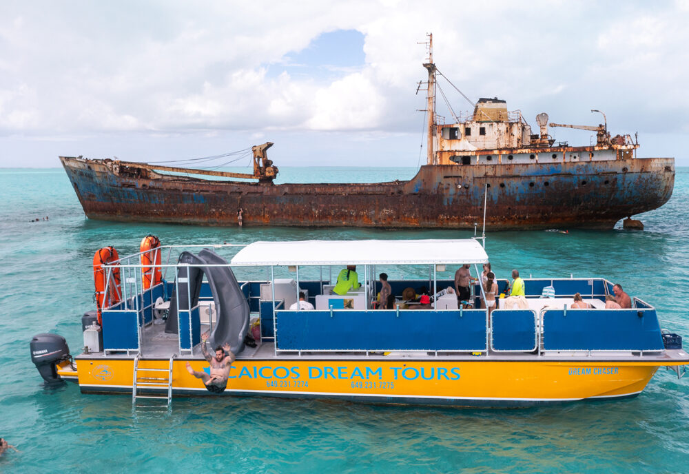 a large blue boat sitting next to a body of water