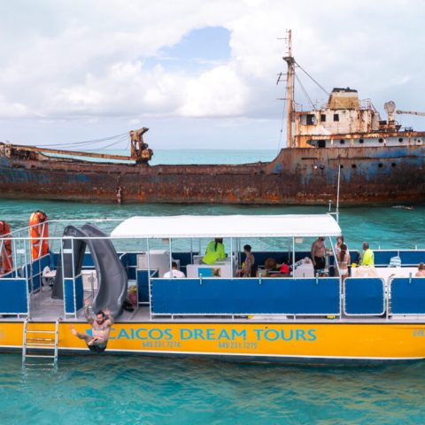 a large blue boat sitting next to a body of water