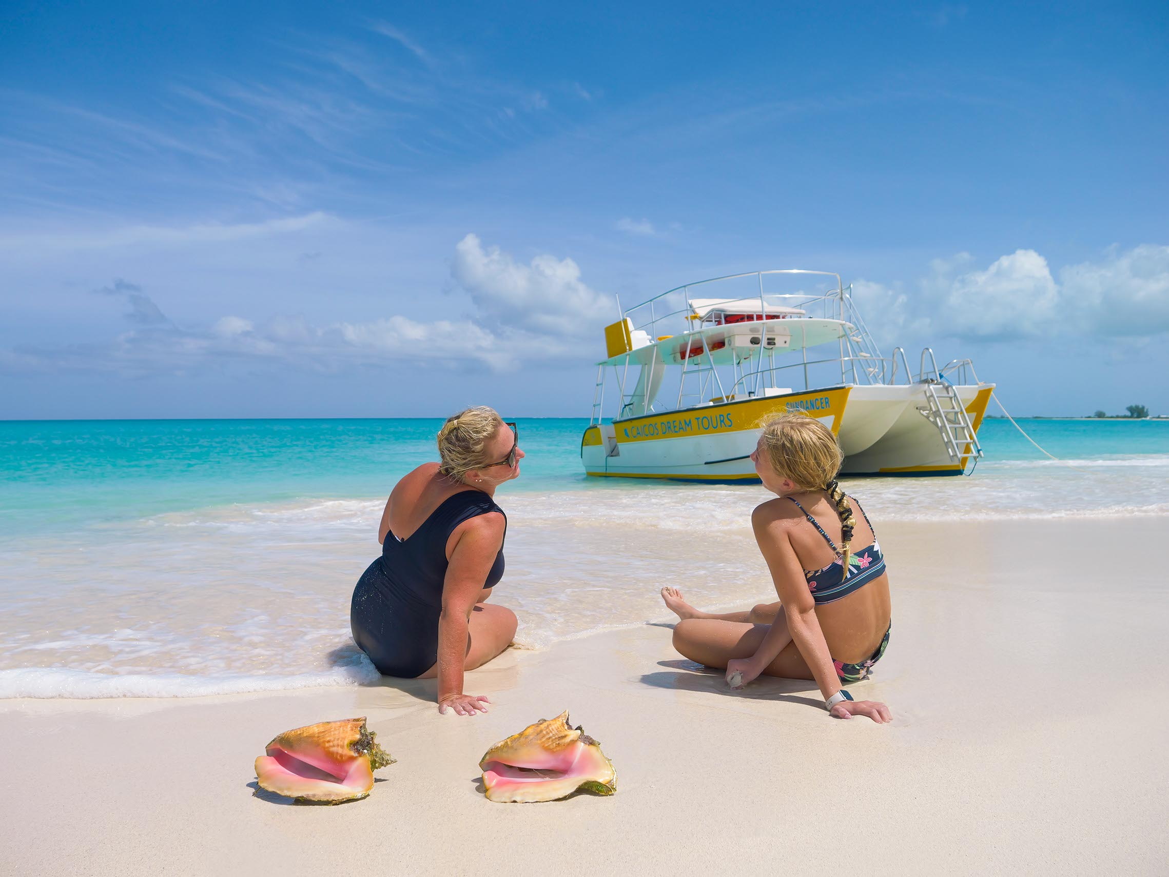 a woman sitting at a beach