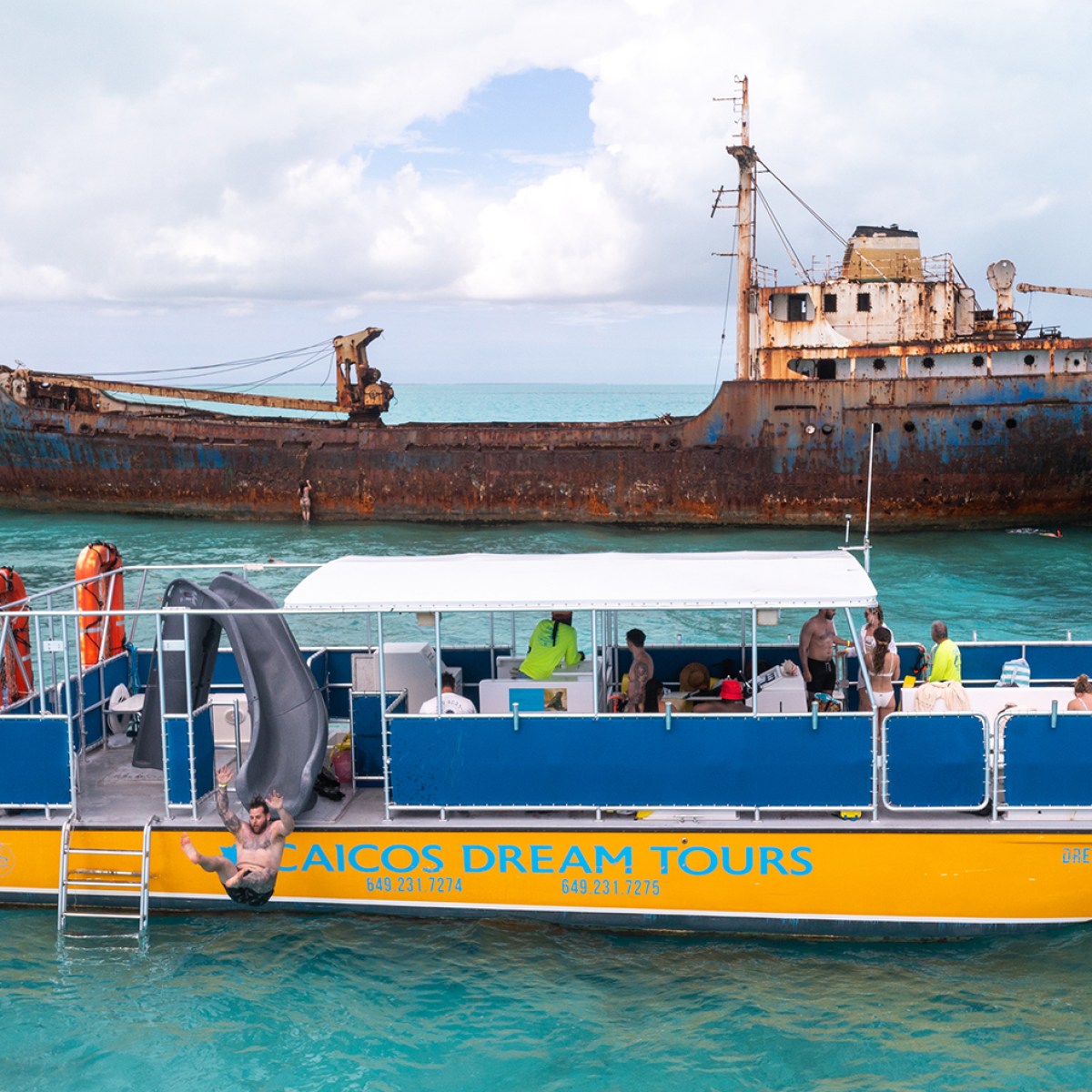 a large blue boat sitting next to a body of water