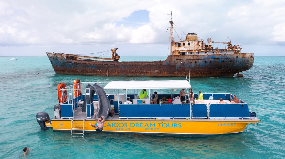 a large blue boat sitting next to a body of water