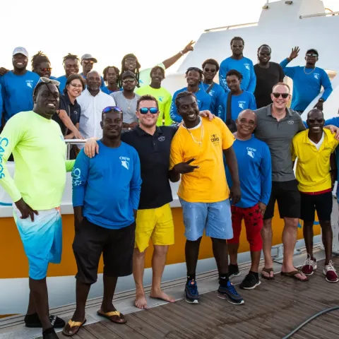 a group of people standing in front of a crowd posing for the camera